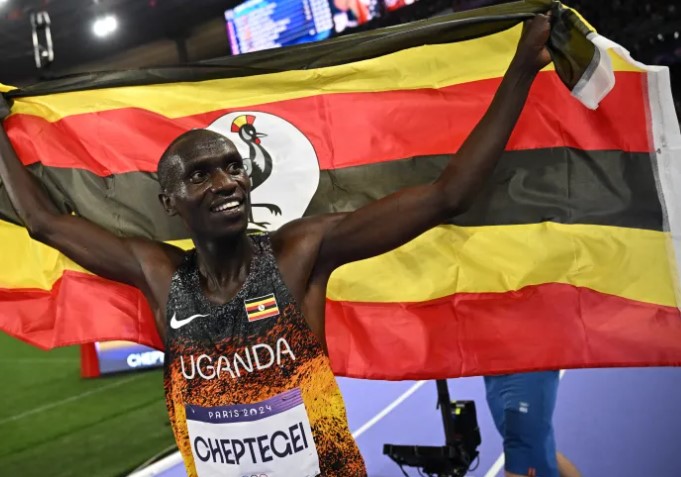 Joshua Cheptegei celebrating his gold medal victory in Paris 2024, inspiring athletes globally with his remarkable achievements