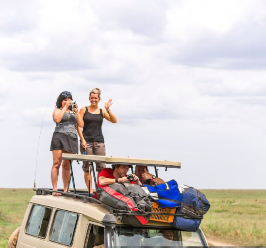 Packing essentials for a Tanzania safari adventure, including clothing and gear.