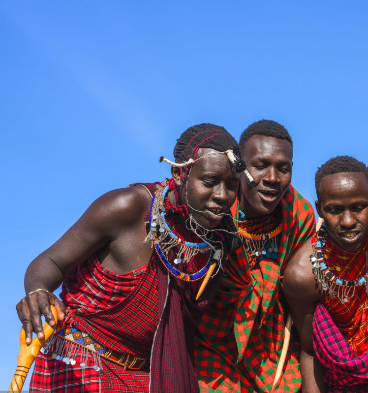 Maasai villagers in traditional attire performing cultural dances in Tanzania.