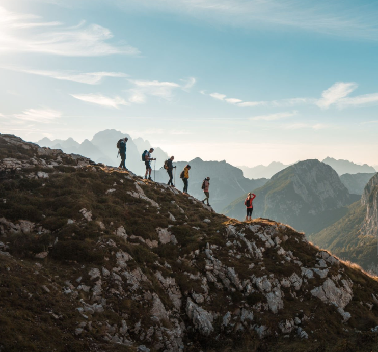 Hikers ascending Mount Karisimbi, Rwanda's highest volcano peak adventure trek.