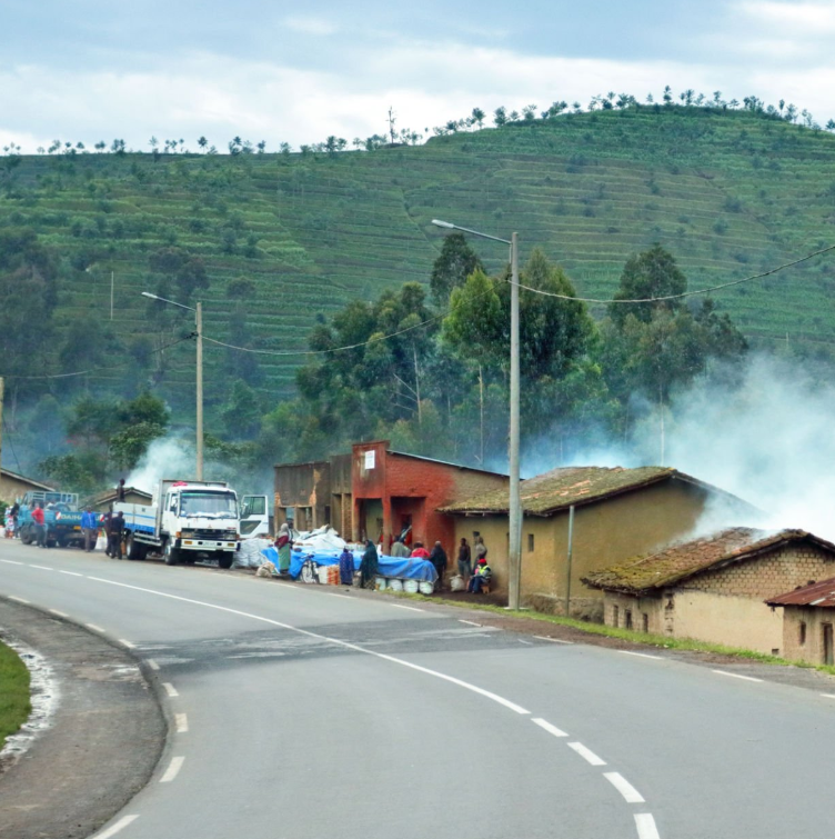 Hiker in Rwanda mountains preventing altitude sickness with proper acclimatization.