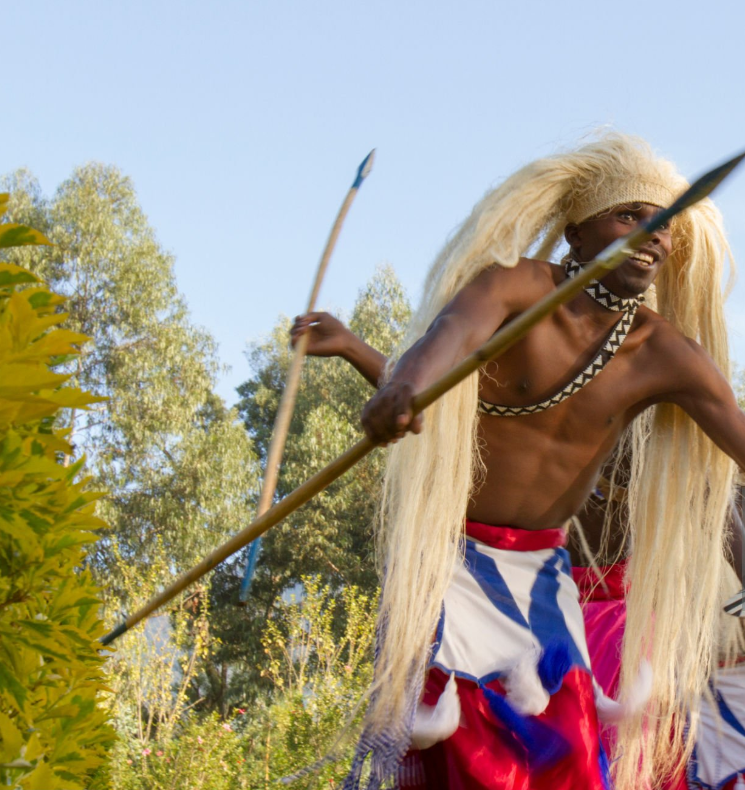 Rwandan Intore dancers performing traditional Rwanda cultural experiences in vibrant attire