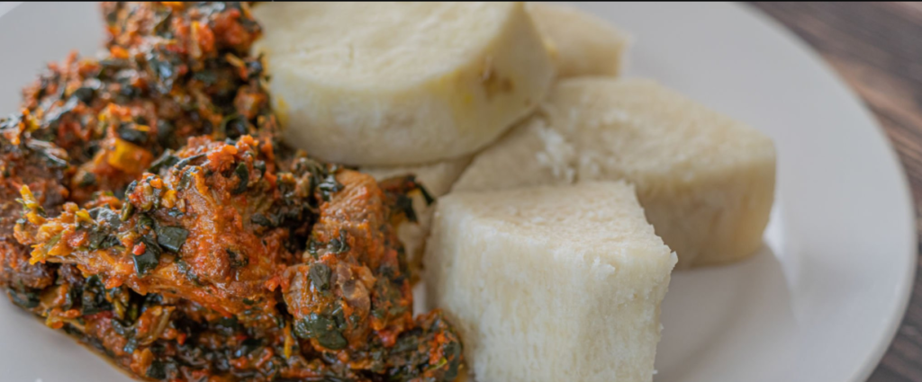 Traditional Rwandan dish Ugali and Isombe served on banana leaf.