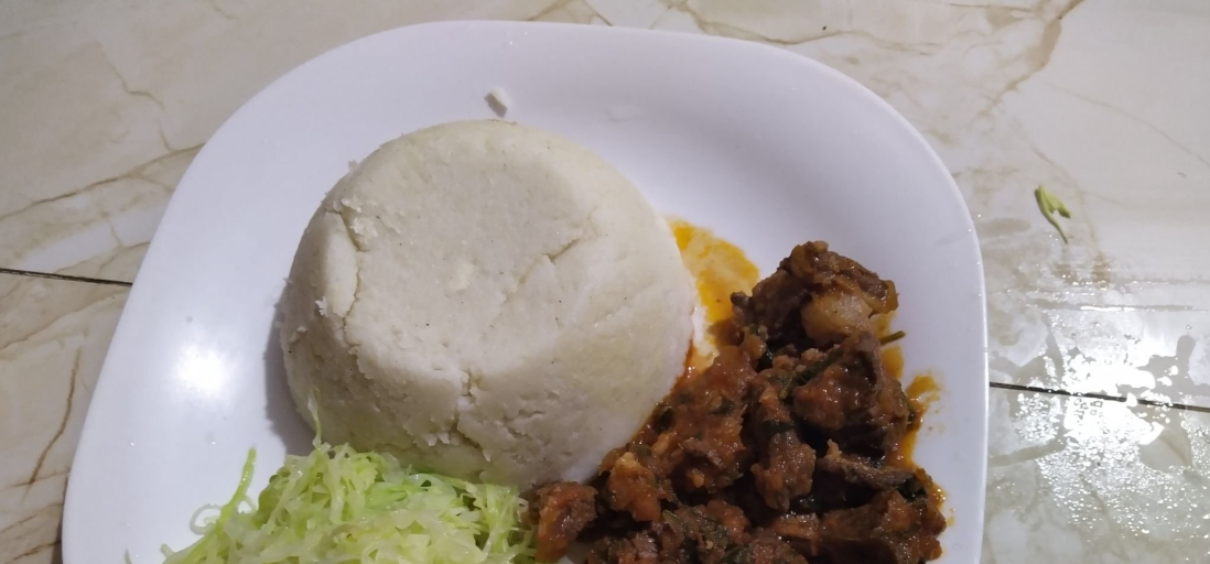 Ugali na nyama choma - Tanzania's national dish of grilled meat and maize porridge.