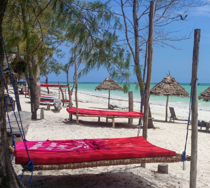 Zanzibar's white sandy beaches and turquoise waters under a clear blue sky.