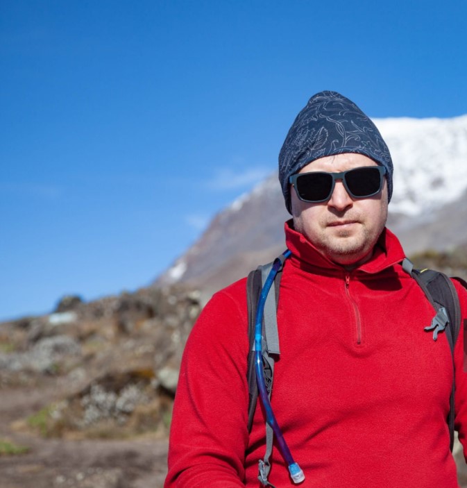 Climbers trekking through Kilimanjaro’s lush rainforest, prepared to prevent altitude sickness with expert guidance.