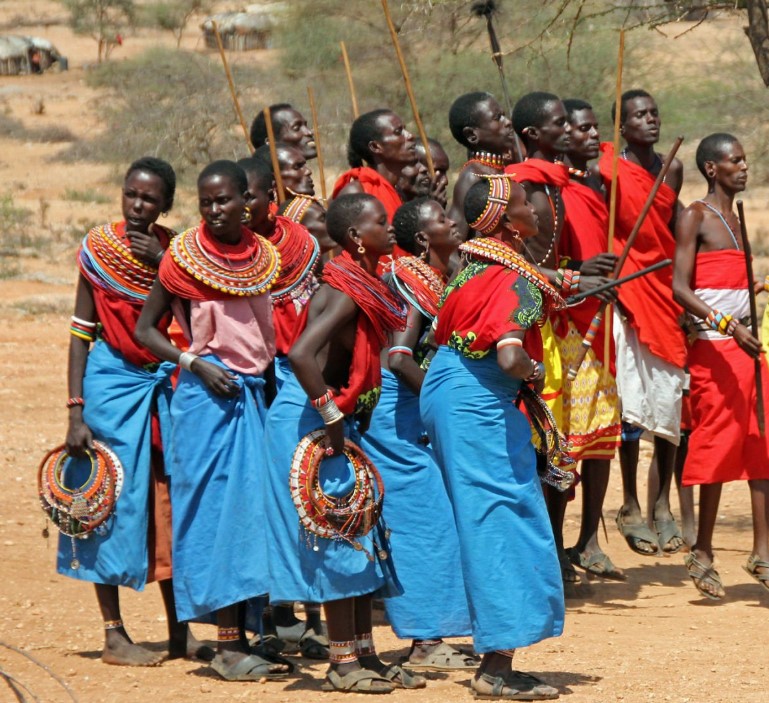 Maasai people in traditional attire performing a cultural dance in Tanzania.