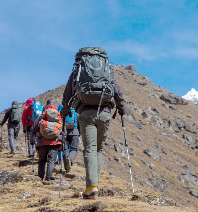 hikers trekking through the rugged terrain of Kilimanjaro, overcoming physical and mental challenges to reach the summit.