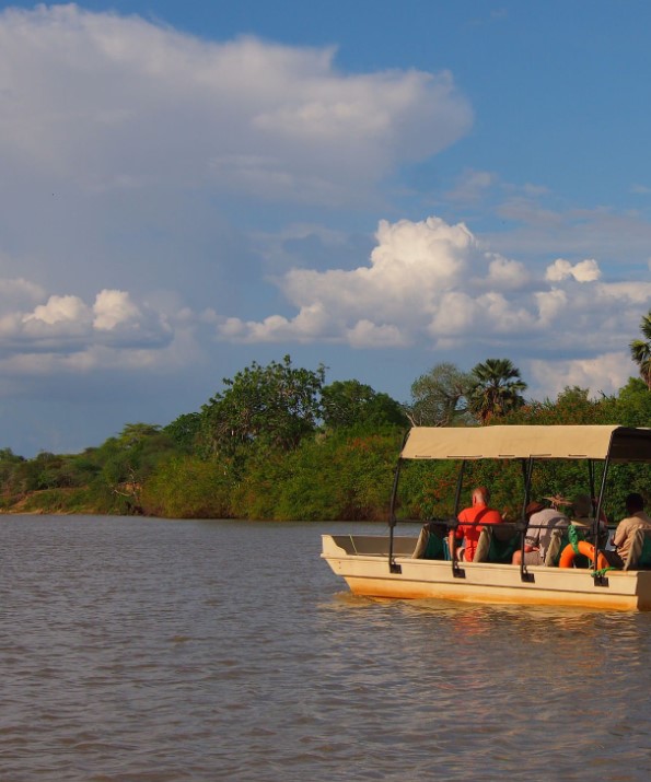 Boat safari on Rufiji River in Selous Game Reserve with wildlife on the banks