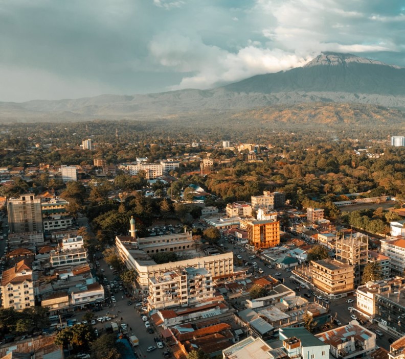 View of Arusha city with Mount Meru in the background, showcasing Tanzania's vibrant culture and landscapes.