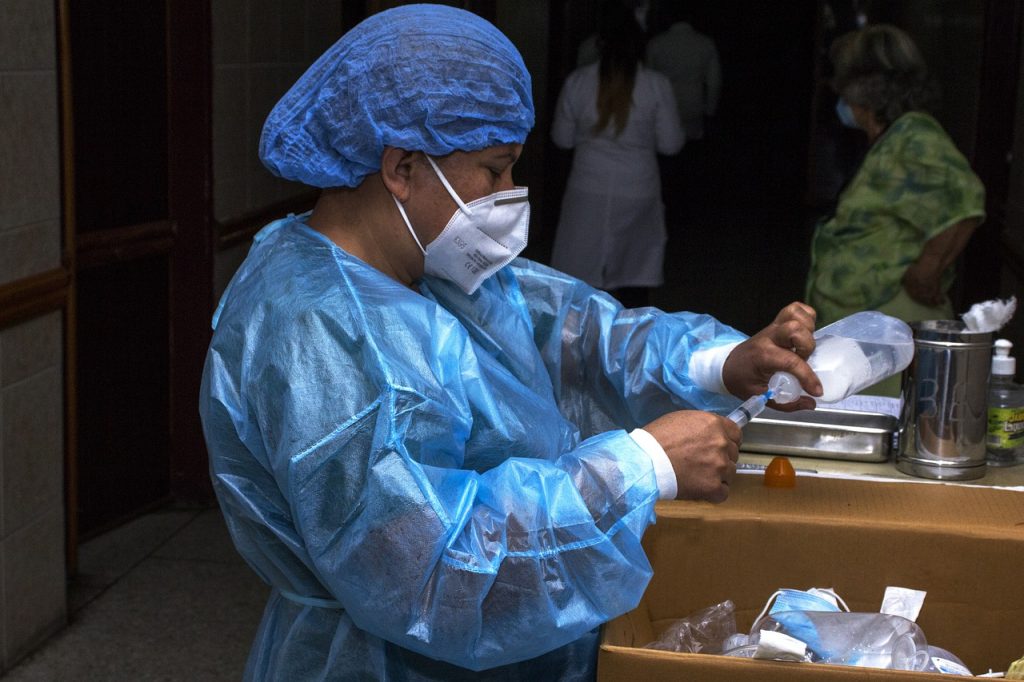 Health care services in Tanzania hospital with medical professionals and patients receiving treatment.