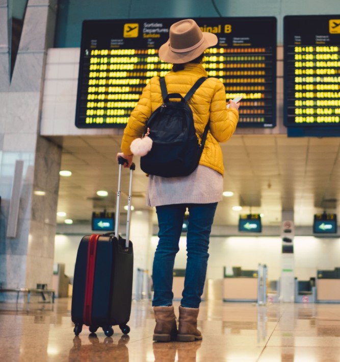 Solo traveler walking through airport terminal with backpack, ready for adventure in Tanzania