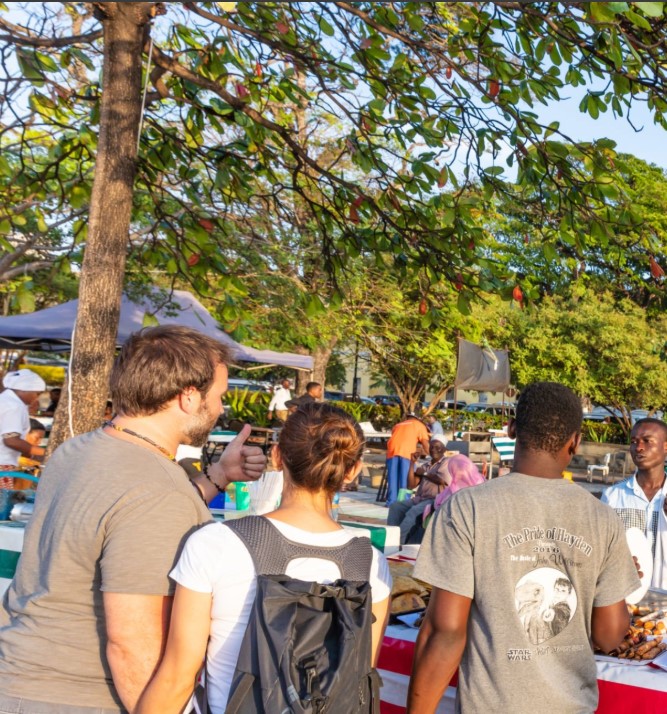 Delicious Zanzibar street food including pizza, samosas, and grilled meats served at local stalls.