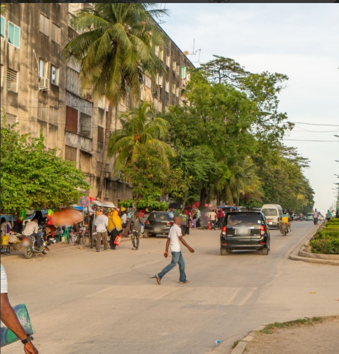 Busy street in Tanzania with pedestrians and vehicles.