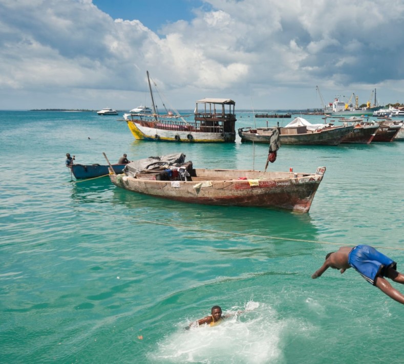 A diver exploring the vibrant coral reefs of Mafia Island.