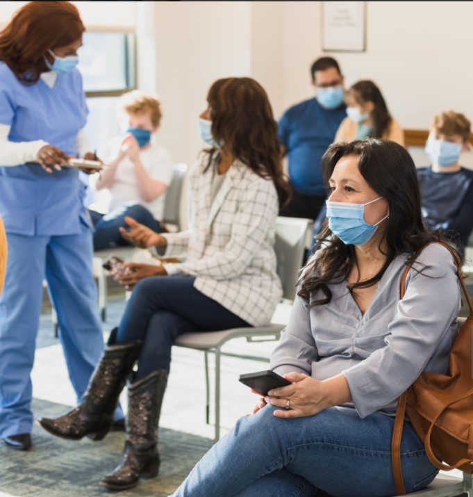 Travelers wearing face masks at a Tanzanian airport, following health protocols and preparing for a safe adventure.
