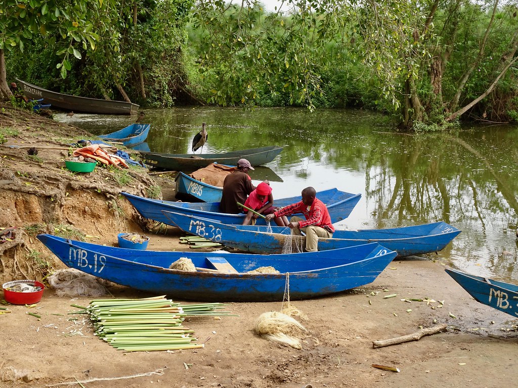 Fishermen with canoes on a Queen Elizabeth National Park channel