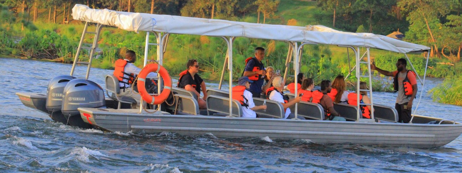 Boat safari with tourists on a Uganda river