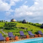 Poolside dome lodges on a hillside in Uganda
